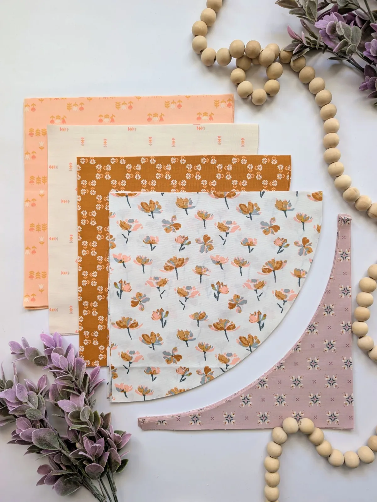 Fabric squares and curved pieces cut with the Neo Curves Ruler for the Neo Quilt
